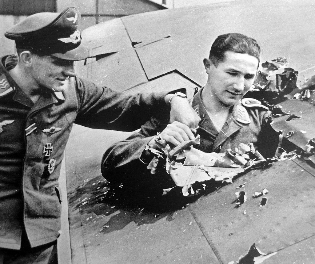 1.British soldiers inspecting .303 bullet holes from British fighters on th...